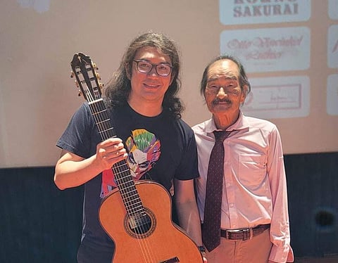 Prizewining guitarist Adrik Cristobal with master guitar maker Masaki Sakurai.