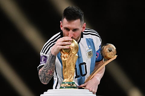 LIONEL Messi kisses the World Cup trophy while holding his Golden Ball plum following Argentina’s victory over France in the final. | KIRILL KUDRYAVTSEV/AGENCE FRANCE-PRESSE