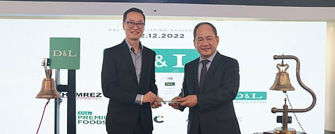 PSE president and CEO Ramon Monzon (left) hands the anniversary plaque to DNL president and CEO Alvin Lao. D&L Industries Inc. celebrated its 10th anniversary as a publicly listed company through a bell ringing ceremony at the Philippine Stock Exchange on 12 December, which is exactly a decade after its initial public offering listing. DNL raised P5.3 billion from the sale of its primary and overallotment shares in 2012. | Photograph courtesy of D&L Industries Inc.