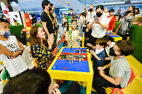 Joy Sotto and family building a Lego tower together. (PHOTOGRAPHS COURTESY OF SM)