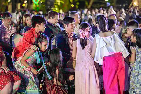 Happiness is… President Ferdinand Marcos on Saturday took time out during the Christmas Tree-lighting ceremony in Malacañang to be with happy, noisy children. On Sunday, Mr. Marcos came back to the Palace grounds to personally lead the handing of Yuletide gifts to kids. | PHOTOGRAPH COURTESY OF Bongbong Marcos Facebook Page
