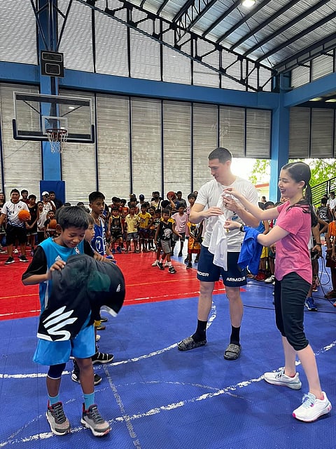 ROBERT Bolick and wife, Cassandra, pay it forward by distributing sports apparel to aspiring basketball players in Ormoc City. | PHOTOGRAPH COURTESY OF CASSANDRA BOLICK