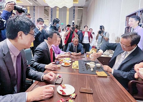 Chinese Ambassador to the Philippines Huang Xilian (right) prepares tea for guests during a recent traditional tea ceremony at the China Embassy. Chinese traditional tea-making is now recognized by the United Nations Education Scientific and Cultural Organization as an “intangible cultural heritage”. | Photograph COURTESY OF CHINESE EMBASSY