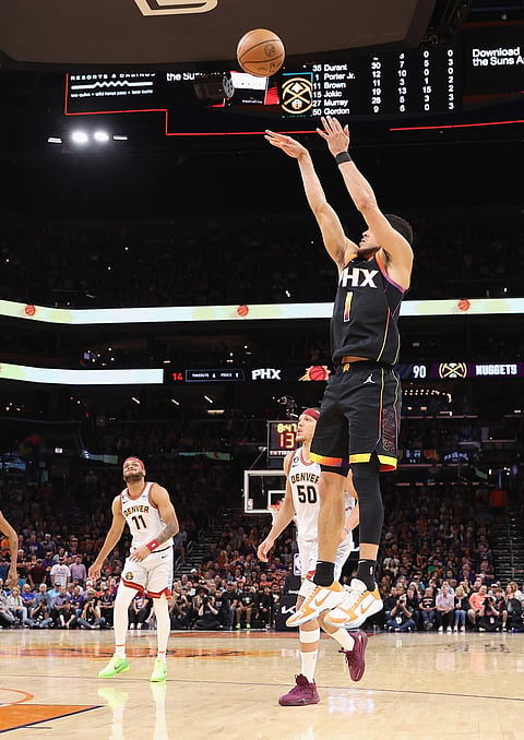 CHRISTIAN PETERSEN/AGENCE FRANCE-PRESSE
Devin Booker lights up the scoreboard when the Phoenix Suns toppled the Denver Nuggets, 121-114, in their NBA semifinal series. Booker hit 47 points to help the Suns cut the deficit to 2-1.

