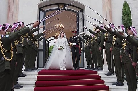 This screen grab taken from a footage released by the Jordanian Royal Palace shows Crown Prince Hussein and his wife Saudi Rajwa al-Seif leaving the Zahran Palace in Amman following their wedding ceremony on 1 June 2023. The ceremony was held in the mid-century Zahran Palace -- the site of other key royal weddings including that of King Abdullah II to Queen Rania as well as that of his father, the late King Hussein bin Talal. (Photo by Jordanian Royal Palace / AFP)