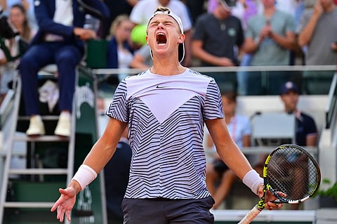 Denmark's Holger Rune celebrates his victory over Argentina's Francisco Cerundolo during their men's singles match on Day Nine of the Roland-Garros Open tennis tournament at the Court Suzanne-Lenglen in Paris. (AFP)