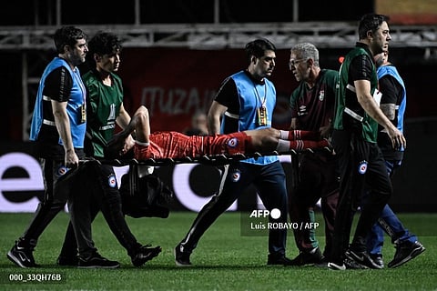 Argentinos Juniors' defender Luciano Sanchez is carried out on a stretcher after being injured during the Copa Libertadores round of 16 first leg football match between Argentina's Argentinos Juniors and Brazil's Fluminense at the Diego Armando Maradona stadium in Buenos Aires, on 1 August 2023. (Photo by Luis ROBAYO / AFP)