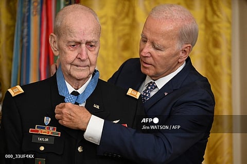 US President Joe Biden presents US Army Captain Larry Taylor (L) with the Medal of Honor during a ceremony in the East Room of the White House in Washington, DC. (Photo by Jim WATSON / AFP)