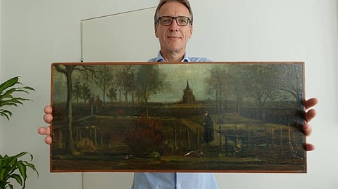 Arthur Brand took possession of the missing painting, the 1884 "Parsonage Garden at Nuenen in Spring", worth between three and six million euros ($3.2 and $6.4 million), at his Amsterdam home on Monday, stuffed in a blue IKEA bag. (Handout / ARTHUR BRAND/AFP)