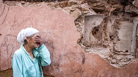 A woman reacts standing infront of her earthquake-damaged house in the old city in Marrakesh on September 9, 2023. A powerful earthquake that shook Morocco late September 8 killed more than 600 people, interior ministry figures showed, sending terrified residents fleeing their homes in the middle of the night.
FADEL SENNA / AFP
