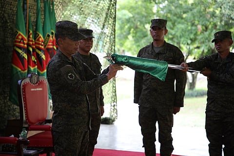 Army Commanding General Lt. Gen. Roy M. Galido unfurls the 11th Field Artillery "Bullseye" Battalion unit flag during its activation on Tuesday at Fort Ramon Magsaysay, Palayan City, Nueva Ecija (Photo by SSg. Cesar Lopez, Philippine Army’s Public Affairs Office)