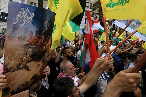 Supporters of Lebanon's Hezbollah movement take to the streets in the southern suburbs of Beirut on 8 October, 2023, in support of the "Operation Al-Aqsa Flood" which was launched by Palestinian Hamas militants the previous day, including a deadly air, land and sea assault into Israel from the Gaza Strip. 