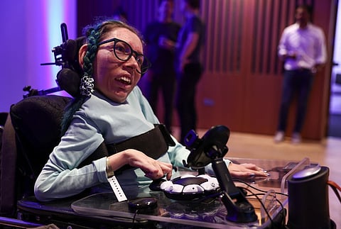 Melanie Eilert tries out the new Playstation Access controller at a demonstration event in London on 5 October 2023. With large buttons arranged in a circle and a joystick on one side, Sony is launching a new PlayStation controller from December, designed to make gaming easier for people with disabilities. (Photo by HENRY NICHOLLS / AFP)