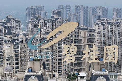 This aerial photo taken on 10 October 2023 shows a logo of China's developer Country Garden Holdings on top of a building in Zhenjiang, in China's eastern Jiangsu province. (Photo by AFP)