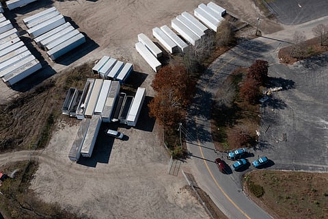 LISBON, MAINE - 28 OCTOBER: In an aerial view, law enforcement officials are seen investigating the area where Robert Card, the suspect in two mass killings, was found dead on 28 October 2023 in Lisbon, Maine. (Photo by JOE RAEDLE / GETTY IMAGES NORTH AMERICA / Getty Images via AFP)
