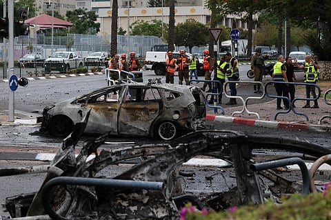 Israeli emergency responders cordon off the site of a rocket attack in the southern Israeli city of Ashdod on 9 October 2023. Israel relentlessly pounded the Gaza Strip early Monday as fighting raged with Hamas around the Gaza Strip and the death toll from the war against the Palestinian militants surged above 1,100. (Photo by AHMAD GHARABLI / AFP)