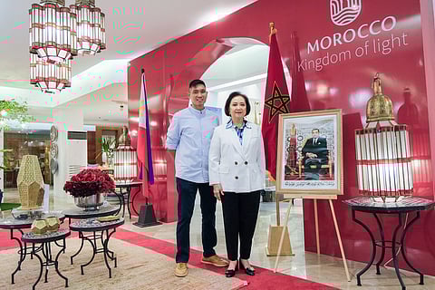 Nedy R. Tantoco, chairperson and CEO of Rustan's Commercial Corporation with Michael T. Huang, senior vice president for Store Development posing beside the portrait of King Mohammed VI of Morocco.