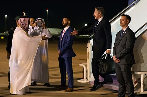 US Secretary of State Antony Blinken is greeted by Saudi Deputy Minister for Protocol Affairs, Abdulmajeed Alsmari in Riyadh on 13 October 2023. Saudi Arabia has denounced the displacement of Palestinians within Gaza and attacks on "defenseless civilians", its strongest language criticizing Israel since the war broke out.  (Photo by Jacquelyn Martin / POOL / AFP)