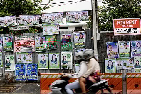 (FILES) Barangay Candidates start hanging a tarpaulin campaign in Quezon, on Thursday 19 October  2023 as the 10-day campaign period for the Barangay and Sangguniang Kabataan Elections (BSKE) begins. The Commission on Elections (Comelec) has reminded the candidates to follow the rules and regulations, including the right size of billboards, tarpaulins, and individual posters, during the campaign period for the 30 October BSKE.
