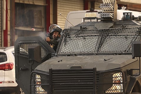 Israeli army surrounds the area of a Palestinian home, believed to belong to one of the gunmen that attacked an Israel checkpoint on the edge of Jerusalem earlier in the day, during a military operation in the occupied West Bank city of Hebron on November 16, 2023, Photo by HAZEM BADER / AFP