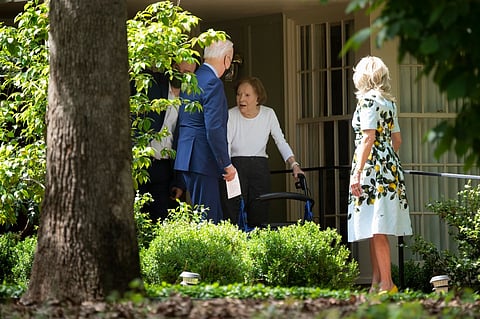 FILE: Former First Lady Rosalynn Carter (C) walks US President Joe Biden and US first lady Dr. Jill Biden out after they after visited former US President Jimmy Carter, 29 April 2021, in Plains, Georgia. (Photo by Brendan Smialowski / AFP)