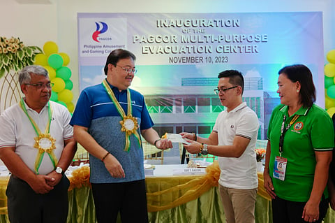 PAGCOR assistant vice president for Community Relations Eric Balcos (second from left) turns over to Mayor Aurelio Rosales III the check representing the third tranche of PAGCOR’s funding for the multi-purpose evacuation center project in Catarman, Northern Samar. With them are PAGCOR senior manager Jake Abejar (left) and Catarman municipal treasurer Marieta Pabello (right). 
