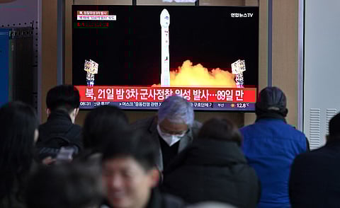 People watch a television screen showing a news broadcast with a picture of North Korea's latest satellite-carrying rocket launch, at a railway station in Seoul on November 22, 2023. Photo by Jung Yeon-je / AFP