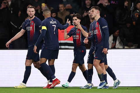 Paris Saint-Germain's Portuguese midfielder #17 Vitinha (C) is congratulated by Paris Saint-Germain's French forward #07 Kylian Mbappe (2L) after scoring PSG's fourth goal during the French L1 football match between Paris Saint-Germain (PSG) and AS Monaco at The Parc des Princes Stadium in Paris on 24 
 November 2023. (Photo by FRANCK FIFE / AFP)