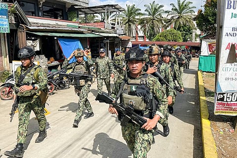 Policemen and soldiers from the military arrive at Mindanao State University in Marawi City, Lanao del Sur province on December 4, 2023, a day after a bomb attack. At least four people died and dozens were wounded on December 3, 2023 in a bomb attack on a Catholic mass in the insurgency-plagued southern Philippines. (Photo by Merlyn MANOS / AFP)