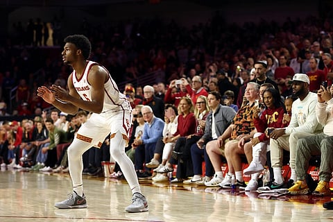 LOS ANGELES, CALIFORNIA - DECEMBER 10: Bronny James #6 of the USC Trojans looks to catch the ball as LeBron James (R looks on ) from the stands during the first half against the Long Beach State 49ers at Galen Center on 10 December 2023 in Los Angeles, California.   Katelyn Mulcahy/Getty Images/AFP (Photo by Katelyn Mulcahy / GETTY IMAGES NORTH AMERICA / Getty Images via AFP)
