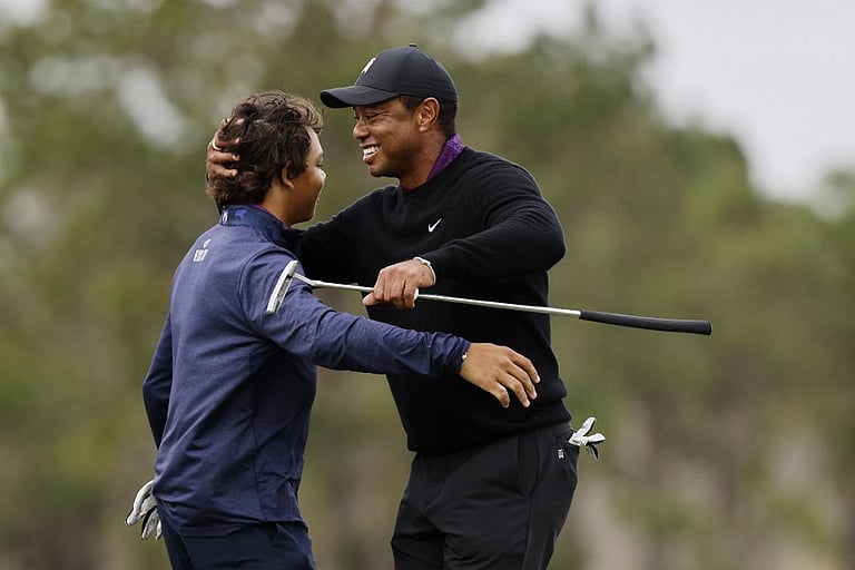 Tiger makes proam walk ahead of title hunt with son Charlie