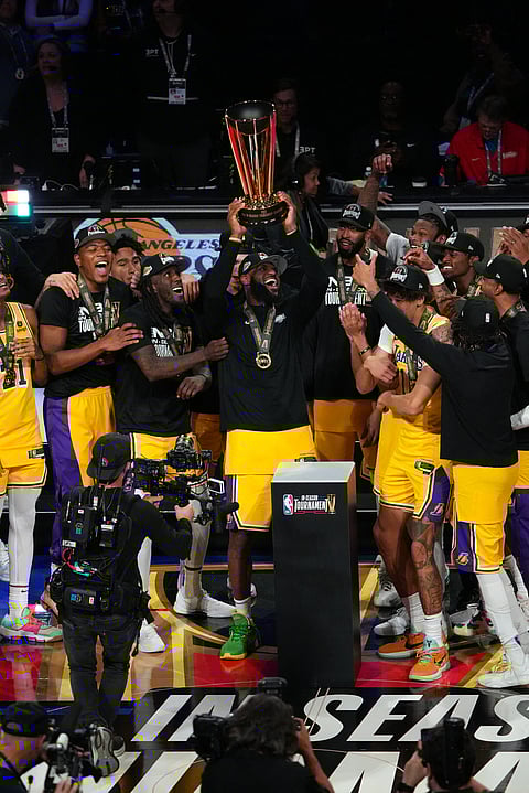 LeBron James and the Los Angeles Lakers celebrate after winning the inaugural NBA in-season tournament by beating the Indiana Pacers, 123-109. | GARRETT ELLWOOD/AGENCE FRANCE-PRESSE