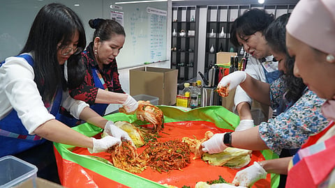 Members of the ASEAN Ladies Foundation try their hands at making kimchi. | PHOTOGRAPHS COURTESY OF THE KOREAN CULTURAL CENTER