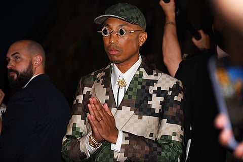 (FILE) US Louis Vuitton' fashion designer and singer Pharrell Williams acknowledges the audience at the end of the Louis Vuitton Menswear Spring-Summer 2024 show as part of the Paris Fashion Week on the Pont Neuf, central Paris, on 20 June 2023. (Photo by STEFANO RELLANDINI / AFP)