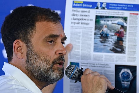 India's Congress party leader Rahul Gandhi holds a printout of news media report on industrialist Gautam Adani during a media briefing on the sidelines of the third meeting of the opposition INDIA Alliance in Mumbai on 31 August 2023. (Photo by INDRANIL MUKHERJEE / AFP)