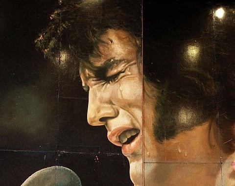 FILE PHOTO: Elvis Presley's 1973 billboard that originally promoted a concert in Hawaii on 6 October, 1999 in Las Vegas. (Photo by JOHN GURZINSKI / AFP)