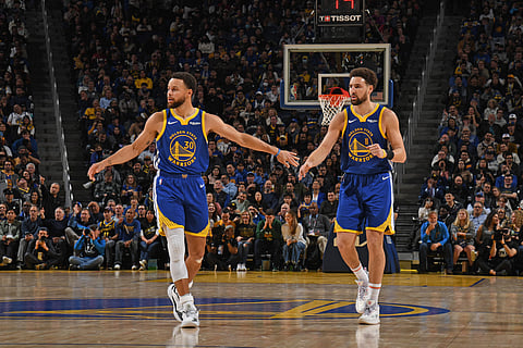 SAN FRANCISCO, CA - 4 JANUARY: Stephen Curry #30 of the Golden State Warriors high fives Klay Thompson #11 of the Golden State Warriors during the game against the Denver Nuggets on 4 January 2024 at Chase Center in San Francisco, California. (Photo by Noah Graham / NBAE / Getty Images / Getty Images via AFP)