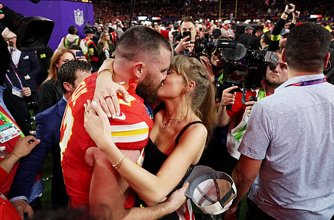 Taylor Swift and boyfriend Travis Kelce of the Super Bowl champion Kansas City Chiefs engage in a lip lock during the 
post-game revelry. | EZRA SHAW/aGENCE 
FRANCE-PRESSE