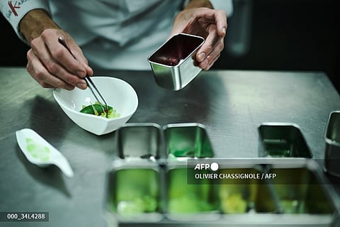 Sebastien Vauxion chef of the Sarkara gourmet, a restaurant with two stars in the Michelin guide prepares a meal at the restaurant's kitchen in Courchevel, French Alps on March 7, 2024. (Photo by OLIVIER CHASSIGNOLE / AFP)
