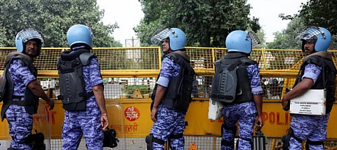 RAF officials with a Delhi police barricade 