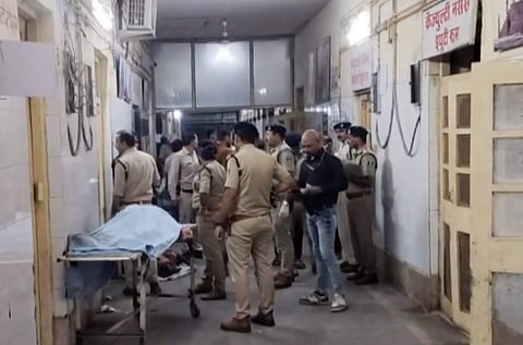 Police personnel attend to an injured victim at a hospital following the Gwalior truck accident.