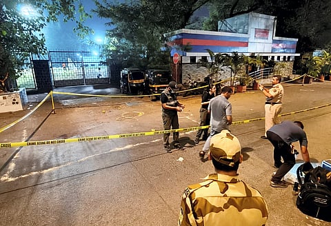  Police and forensic officials conduct investigation at the crime scene where gunmen opened fire at Bollywood actor Tiger Shroff.