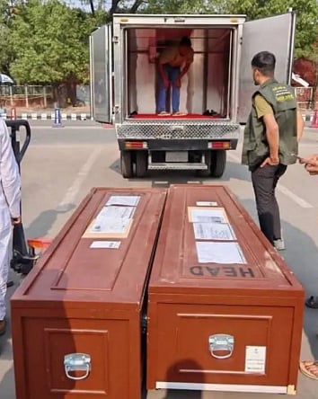 Coffins of the two Bangladeshi people being taken for cremation