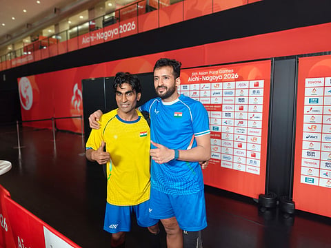 India's Nitesh Kumar, right, and Pramod Bhagat, pose for a photograph after winning gold and silver medals respectively in men's singles SL3 event during the ongoing 5th Asian Para Games, in Nagoya, Japan.