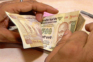 Rupee trims early gains Vs dollar, still up 12 paise