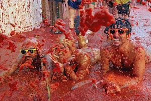 Annual tomato battle paints streets of Spanish town red