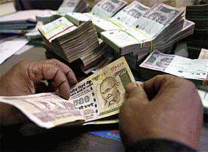 Rupee gains vs dollar, up 14 paise in late morning deals