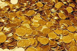 Gold inches up in futures trade on firm global cues
