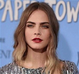Delevingne uses water guns to keep paparazzi at bay