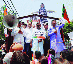 AAP Govt's 'watered down' promises see restive BJP break earthen pots in protest